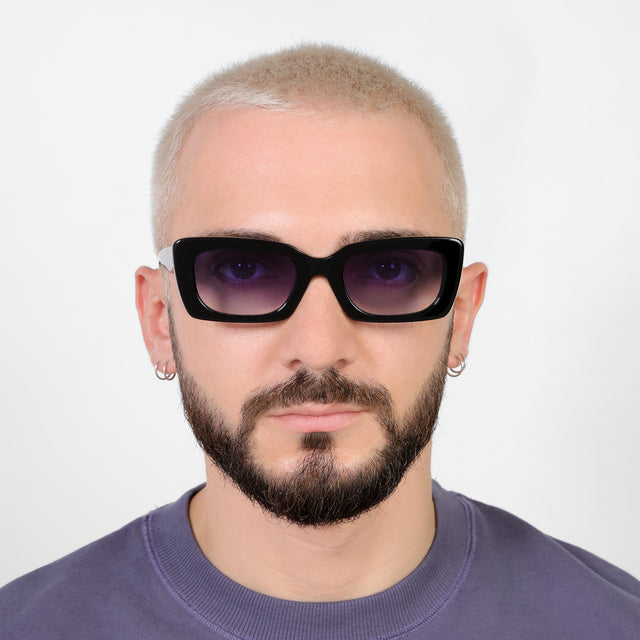 Model with a platinum buzzcut wearing Wilson Sunglasses Black with Purple Flat Gradient