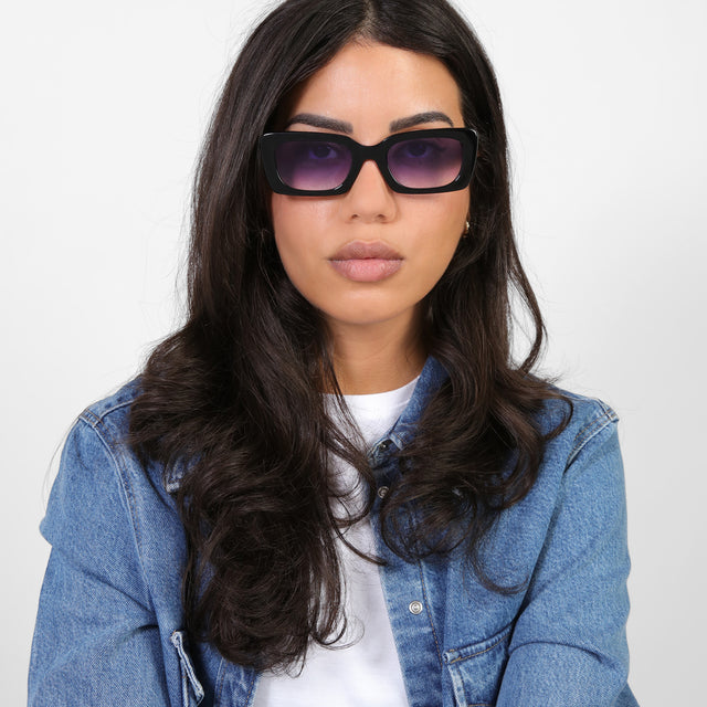 Brunette model in a denim jacket wearing Wilson Sunglasses Black with Purple Flat Gradient