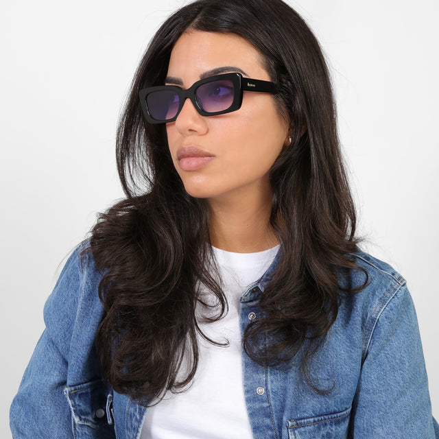 Brunette model looking right wearing Wilson Sunglasses Black with Purple Flat Gradient