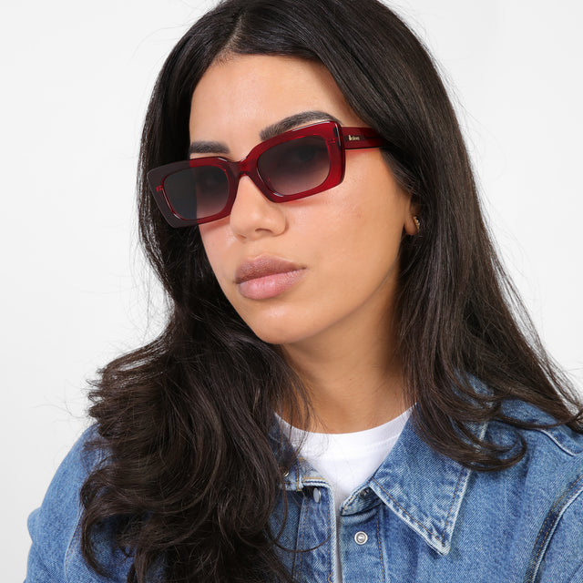 Brunette model in a denim jacket wearing Wilson Sunglasses Mulberry with Grey Flat Gradient 