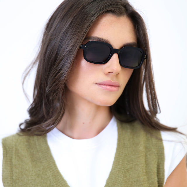 Brunette model in a wool vest wearing Berlin Sunglasses Black with Grey