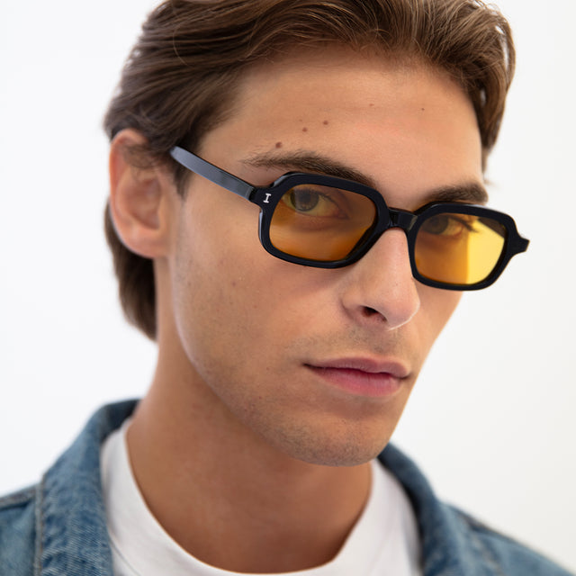 Model with light brown hair combed back wearing Berlin Sunglasses Black with Grey
