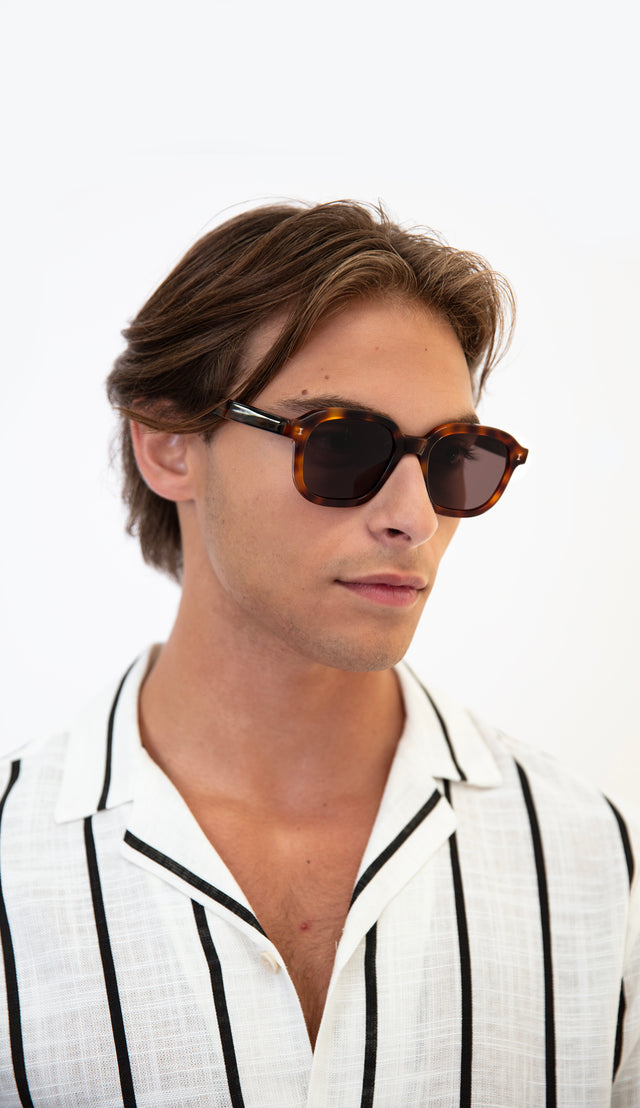 Model wearing Bogota Havana with Brown and a striped, collared linen shirt