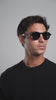 Man wearing the Washington Sunglasses in Black while turning his head