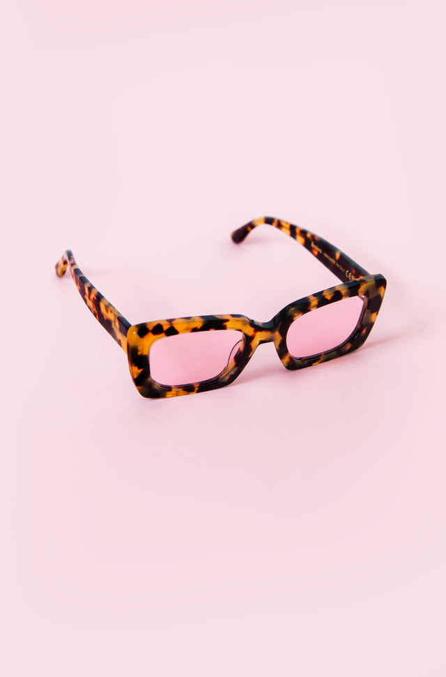 A pair of glasses on a pink background