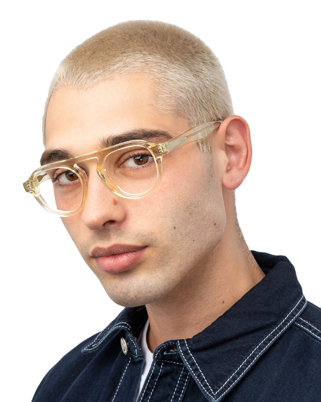 Model with blonde buzzcut wearing Bergen II Optical Champagne Optical