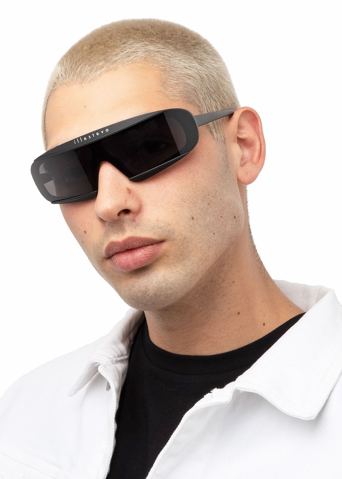 Model wearing Courchevel Sunglasses in Matte Black with Grey lenses, Blonde man with buzzcut