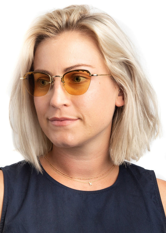 Blonde model with shoulder-length straight hair Sorrento Sunglasses side view in Gold / Honey Flat See Through