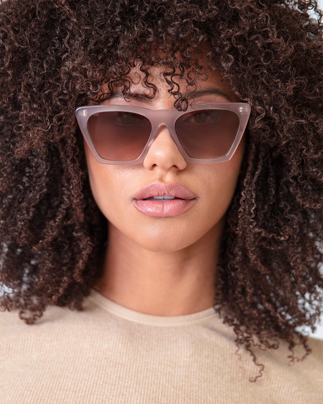 Brunette model with afro-curly hair wearing Lisbon Sunglasses Thistle with Brown Gradient