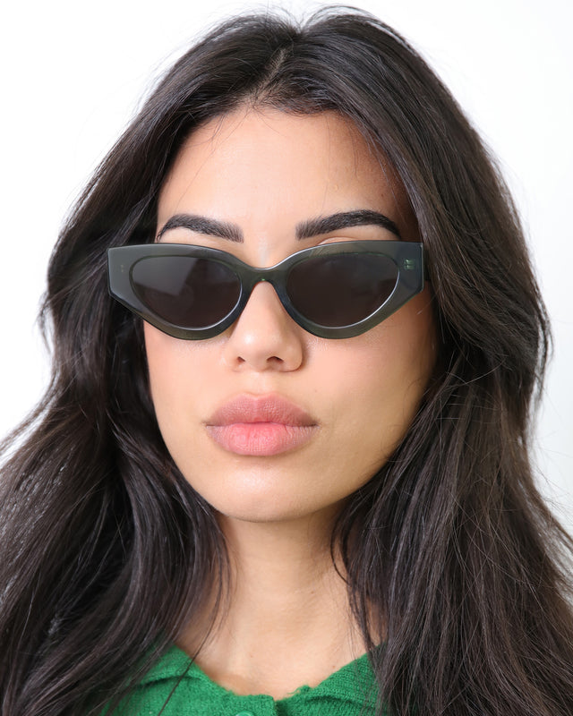 Brunette Woman wearing Mary Lou 51 Sunglasses Pine with Grey Flat