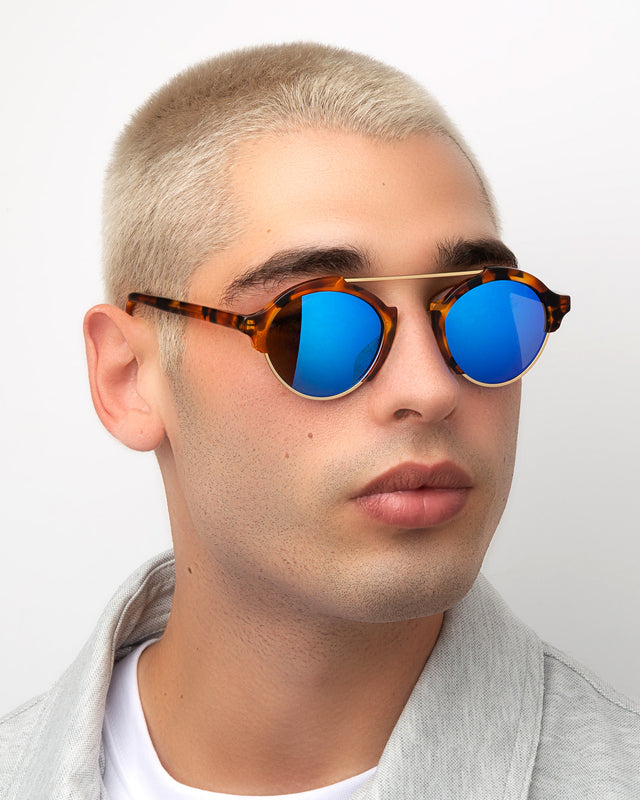 Man with blonde buzzcut wearing Milan IV Sunglasses Light Tortoise Blue Mirror