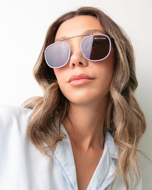 Brunette model with ombre wavy hair wearing Mykonos Ace Sunglasses Lilac/Gunmetal with Grey Flat