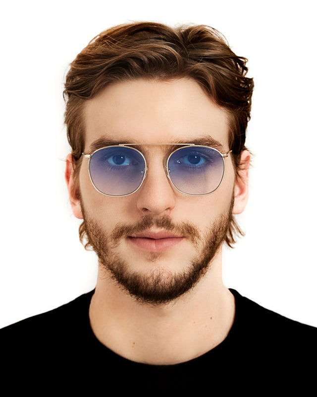 Bearded model in black shirt wearing Mykonos II Sunglasses Gold with Blue Flat Gradient See Through
