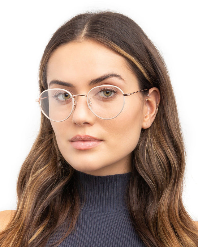 Brunette model with wavy hair wearing Oxford 52 Optical Linen/Rose Gold Optical