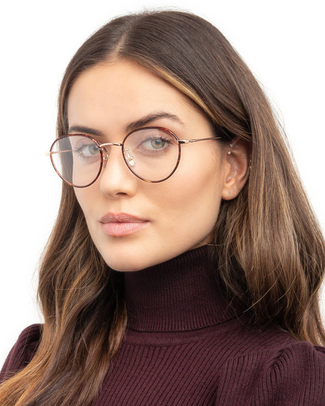 Brunette model with wavy hair wearing Oxford 52 Optical Red Tortoise/Rose Gold Optical