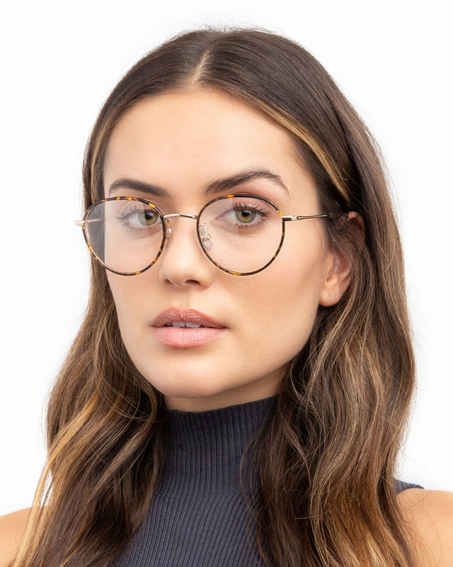Brunette model with wavy hair wearing Oxford 52 Optical Tortoise/Gold Optical