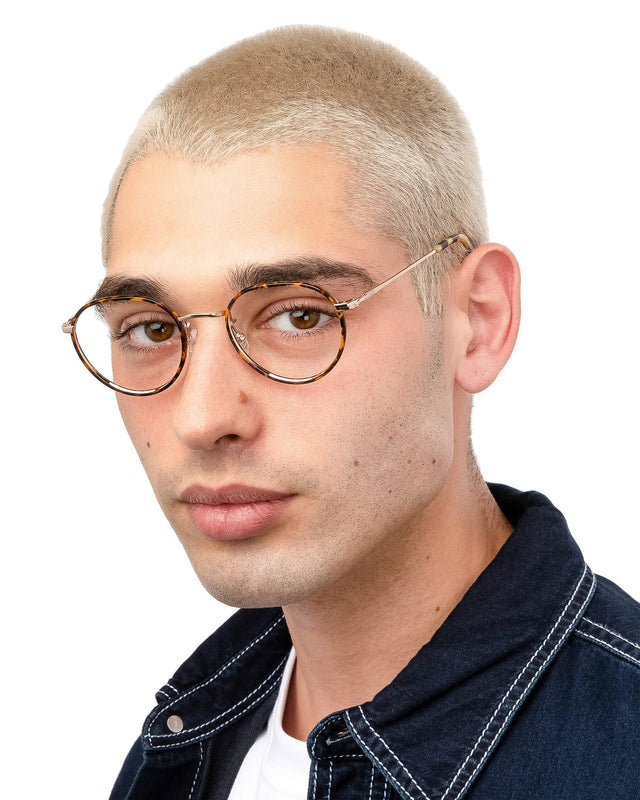 Model with blonde buzzcut  wearing Oxford Optical Tortoise/Rose Gold Optical