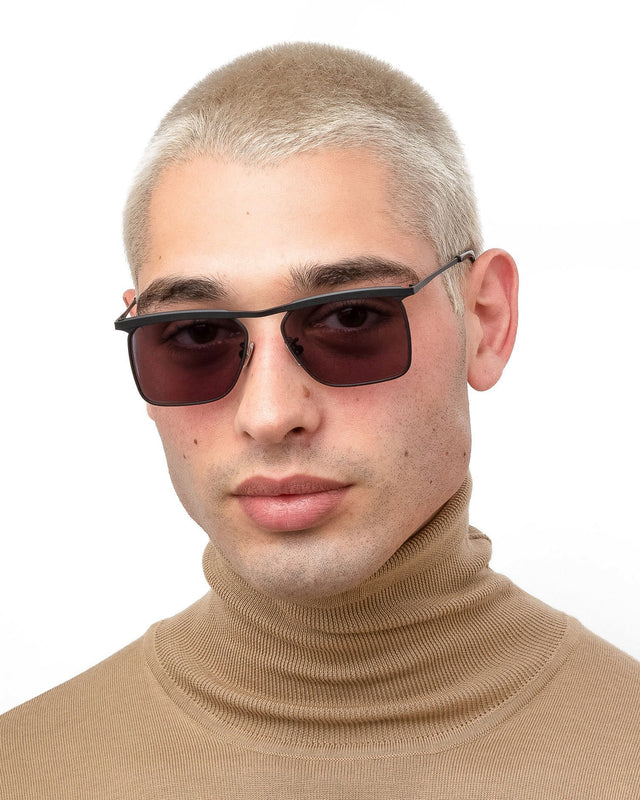 Model with blonde buzzcut wearing PCH Sunglasses Matte Black with Grey Flat