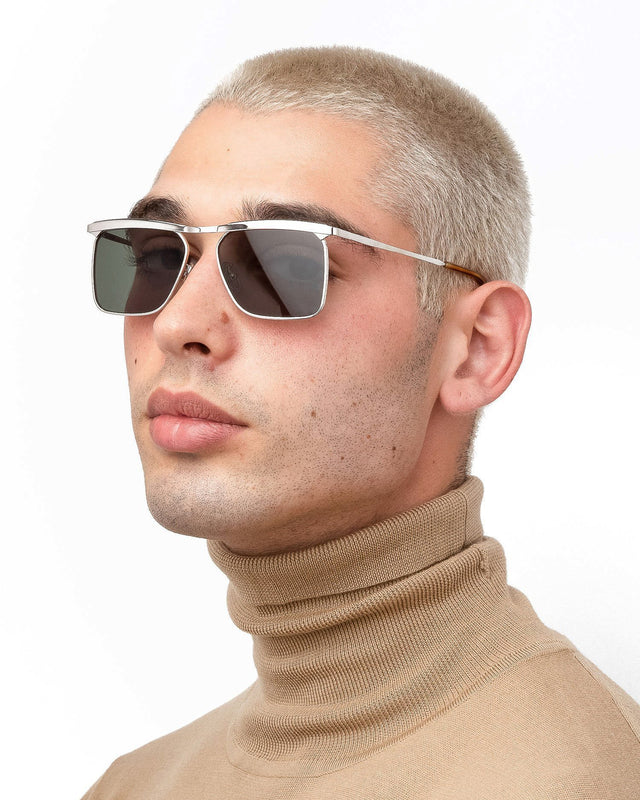 Model with blonde buzzcut wearing PCH Sunglasses Silver with Olive Flat Lenses