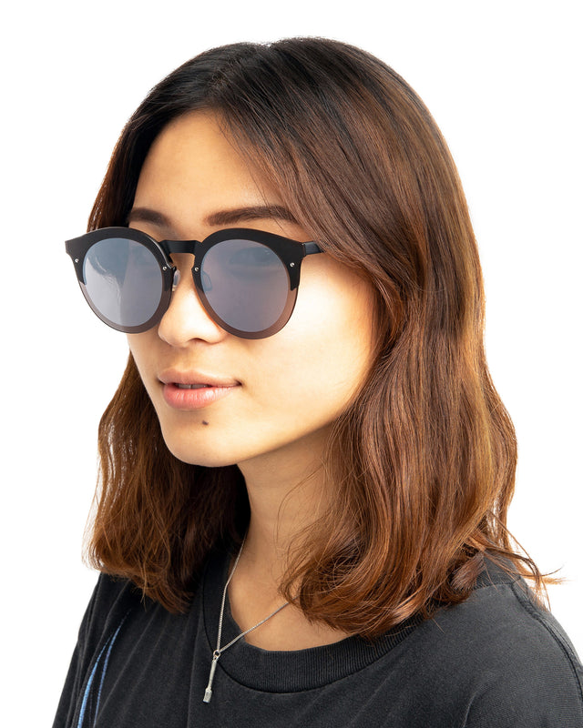 Brunette model with wavy hair wearing Palermo Sunglasses Matte Black with Grey Flat