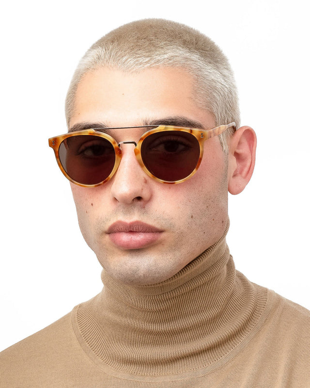 Model with blonde buzzcut wearing Puglia Sunglasses Amber/Rose Gold with Grey Flat
