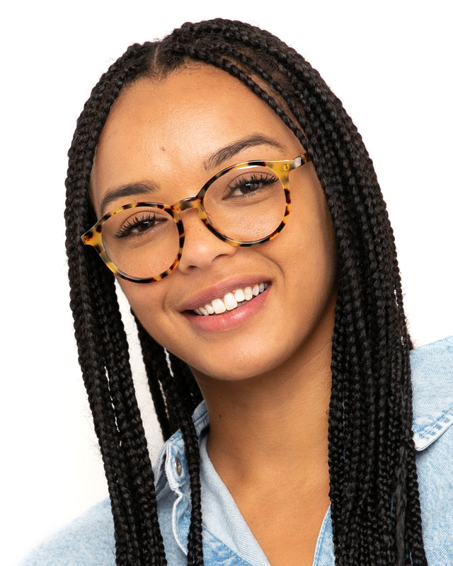 Brunette model with box braids wearing Twain Optical Tortoise Optical